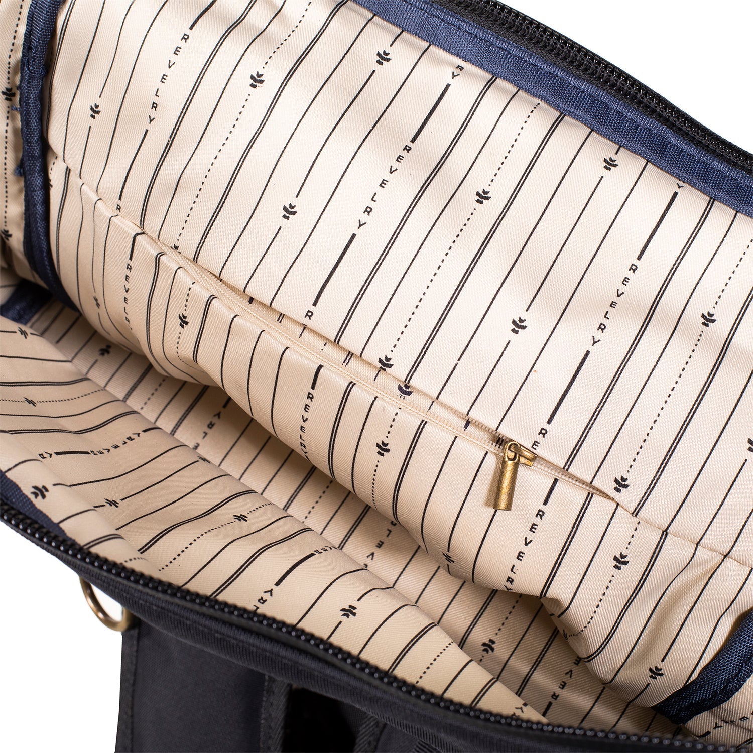 Close-up of a bag with striped lining and visible brand name.