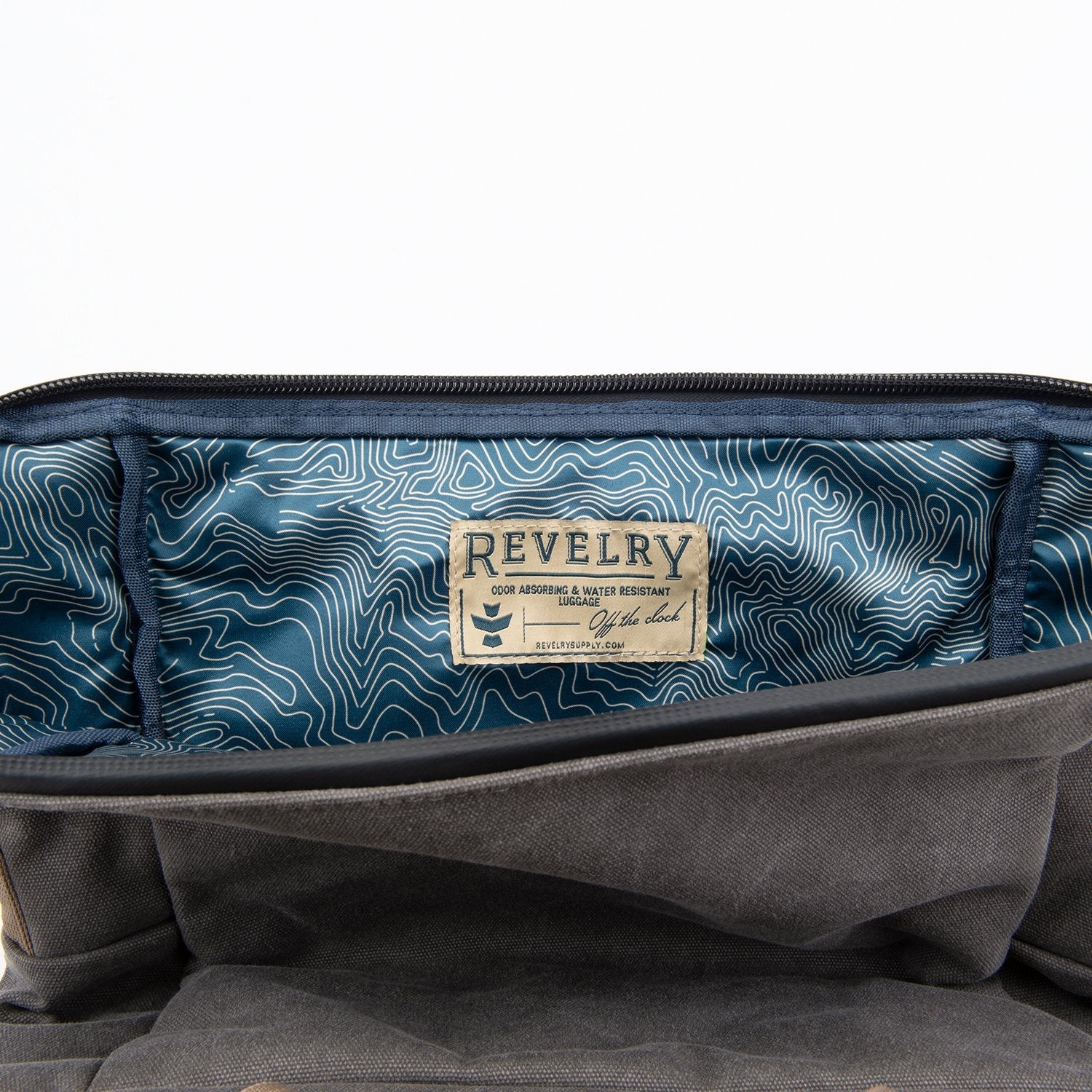 Gray bag with a blue interior and 'Revelry' label on a white background