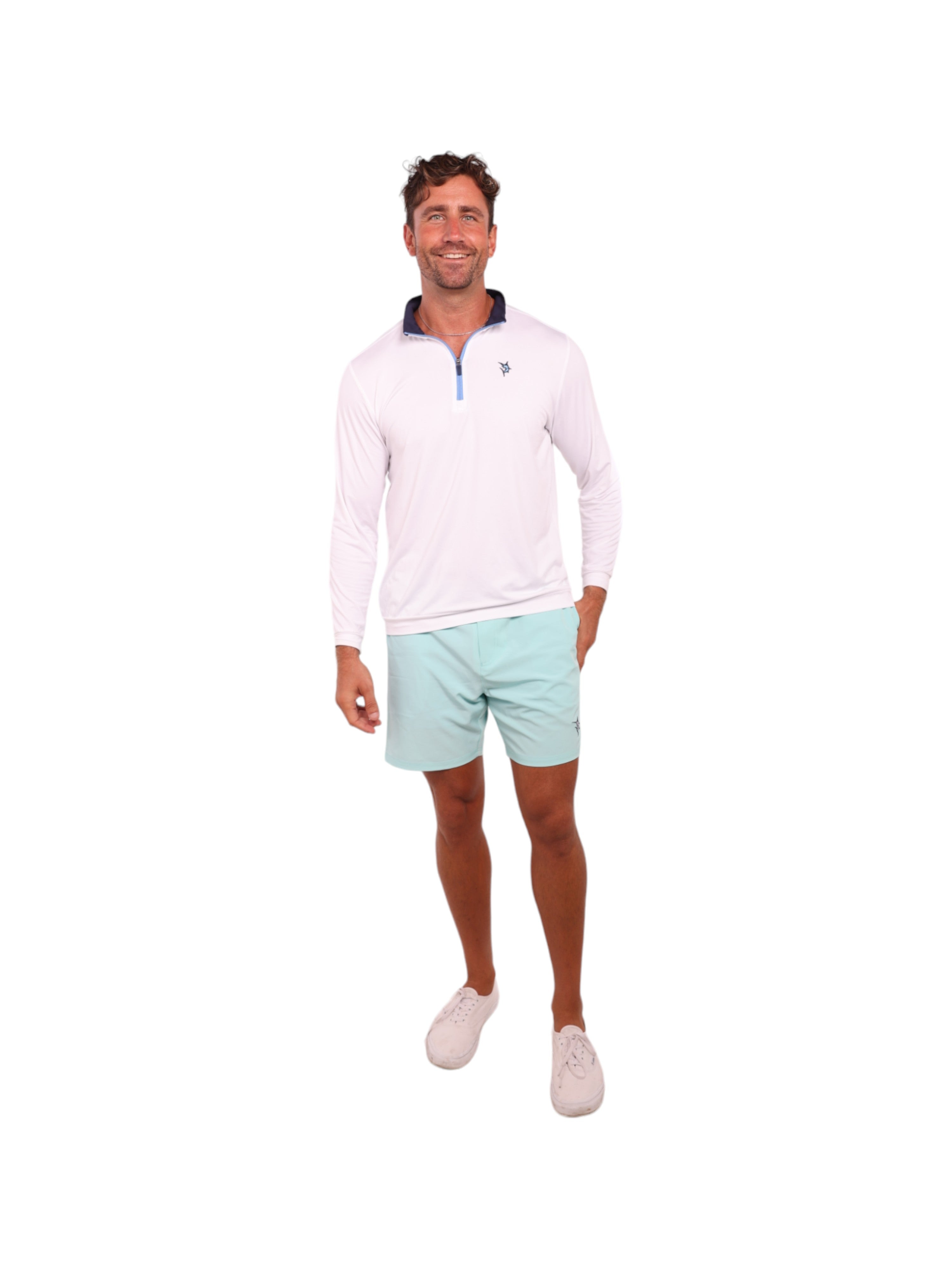 Man wearing a white long-sleeve shirt and light blue shorts on a white background