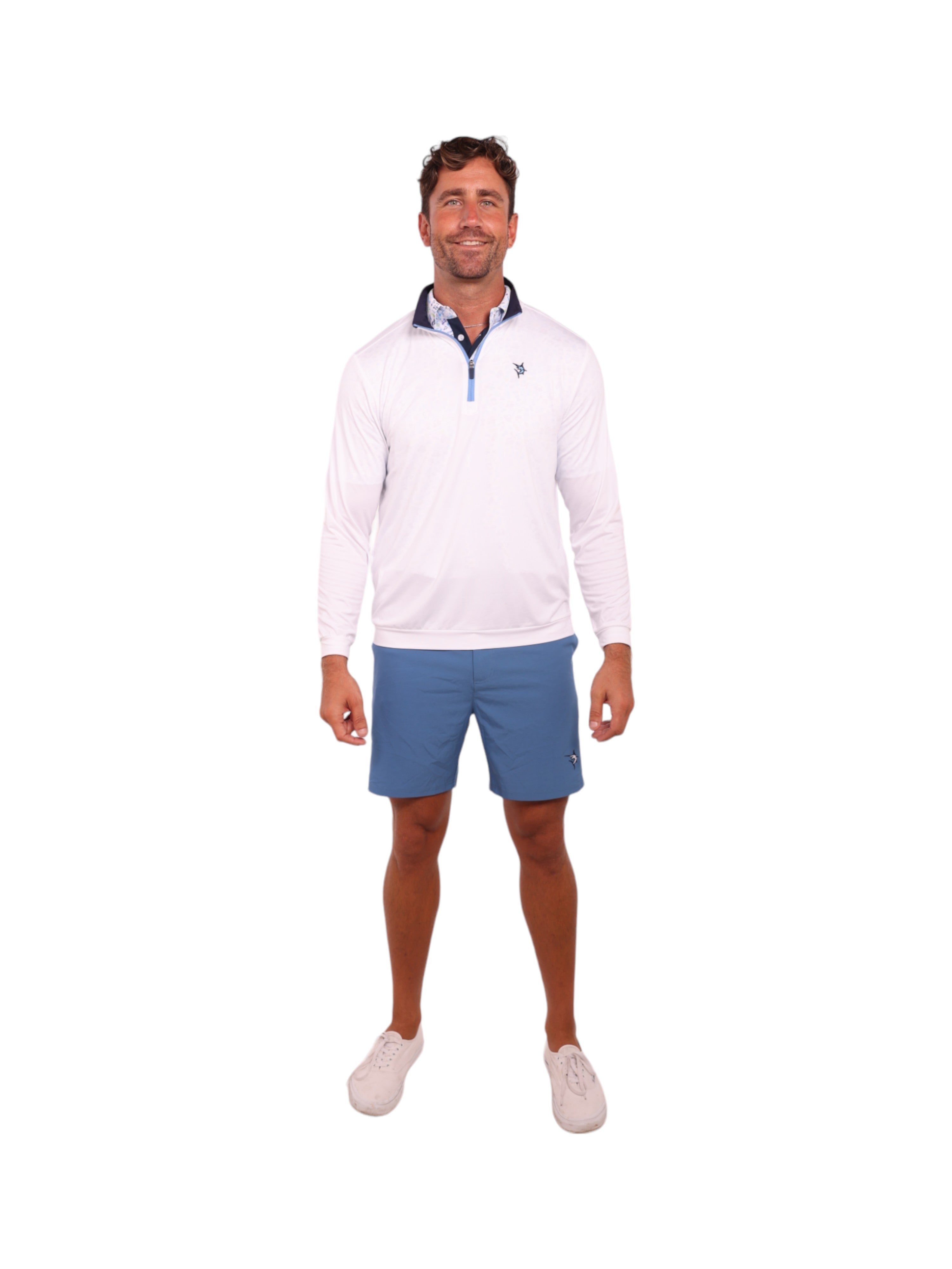Man wearing a white quarter-zip sweater and blue shorts on a white background