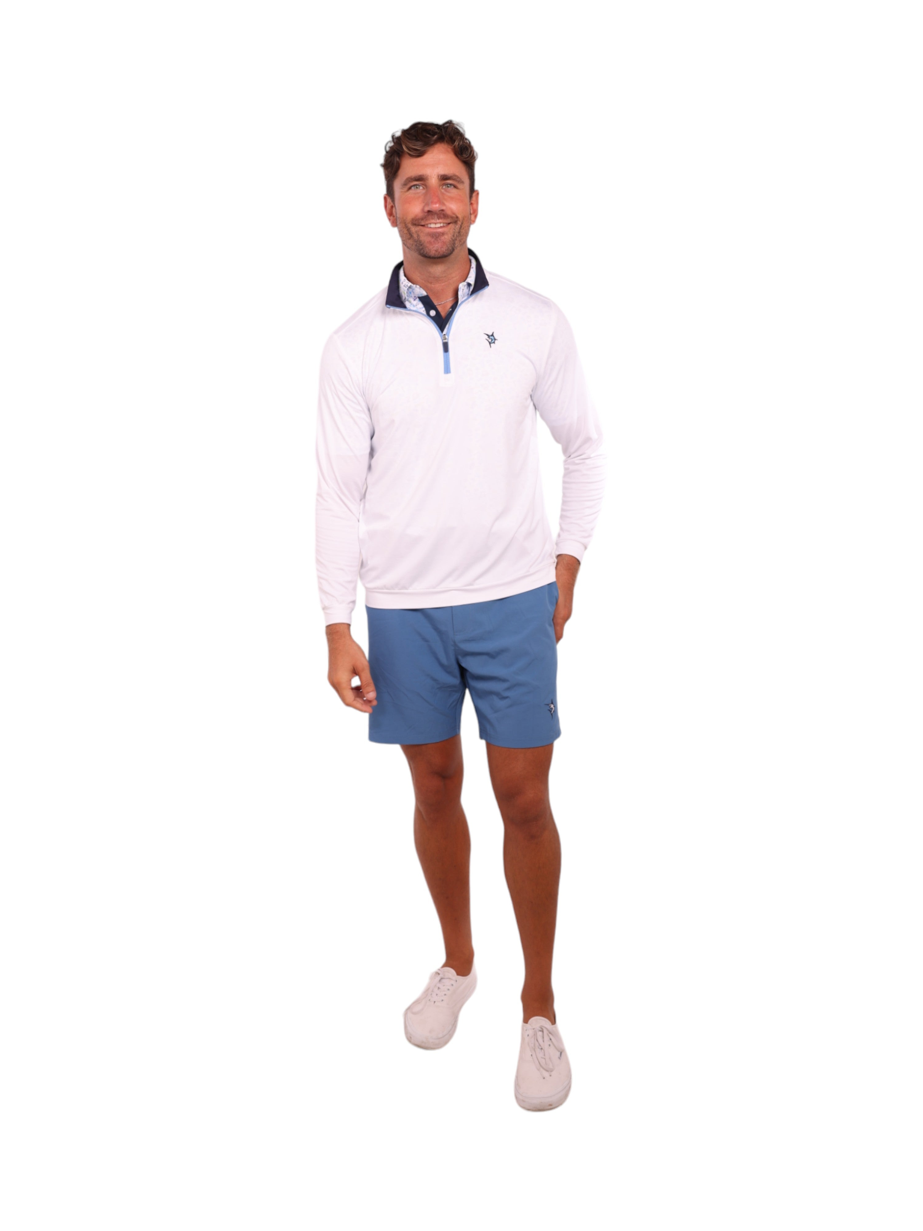 Man wearing a white long-sleeve shirt and blue shorts on a white background