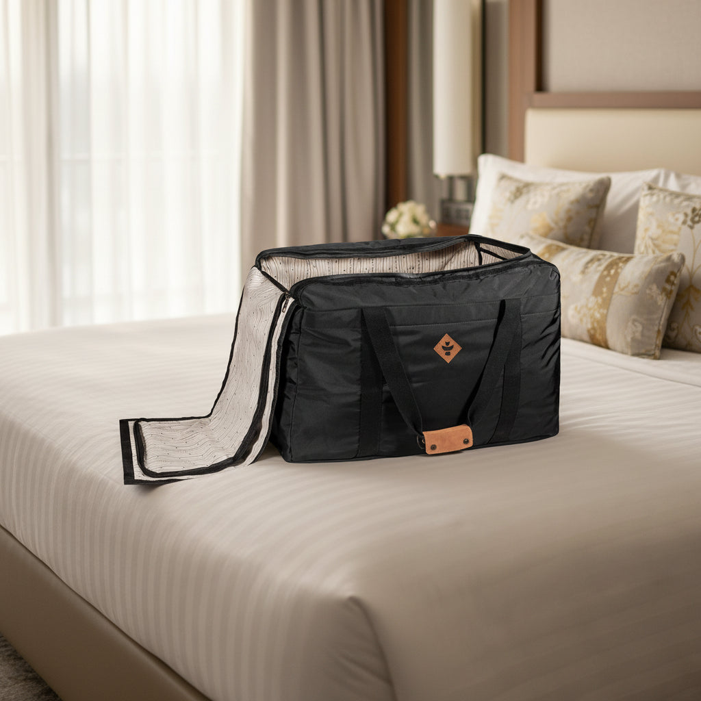 Black travel bag with a beige interior on a white background