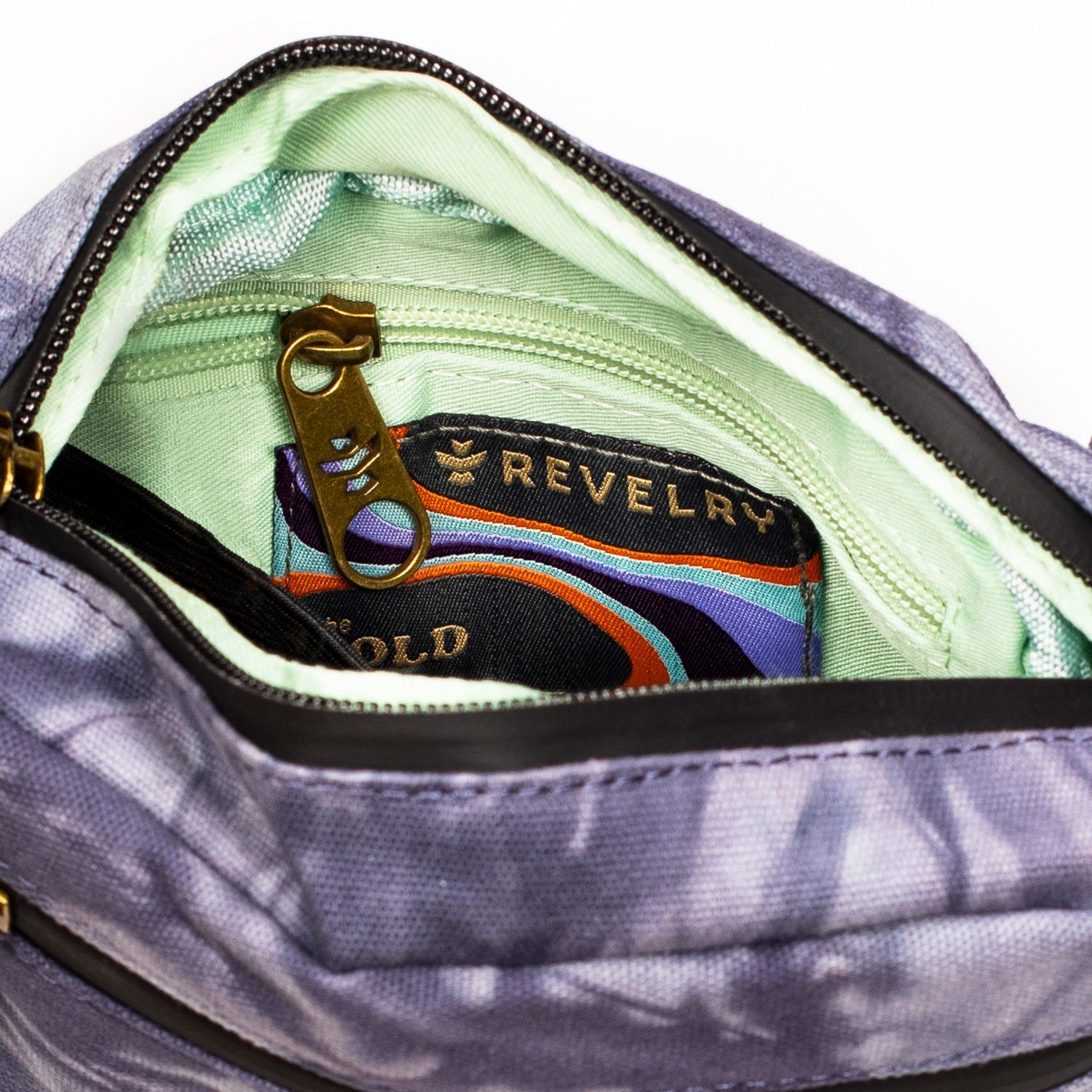 Open bag revealing a colorful pouch with 'Revelry' branding inside.