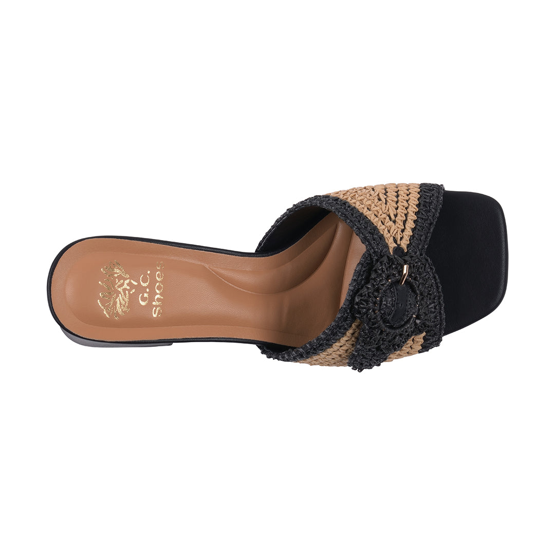 Black and brown sandal with woven details on a white background