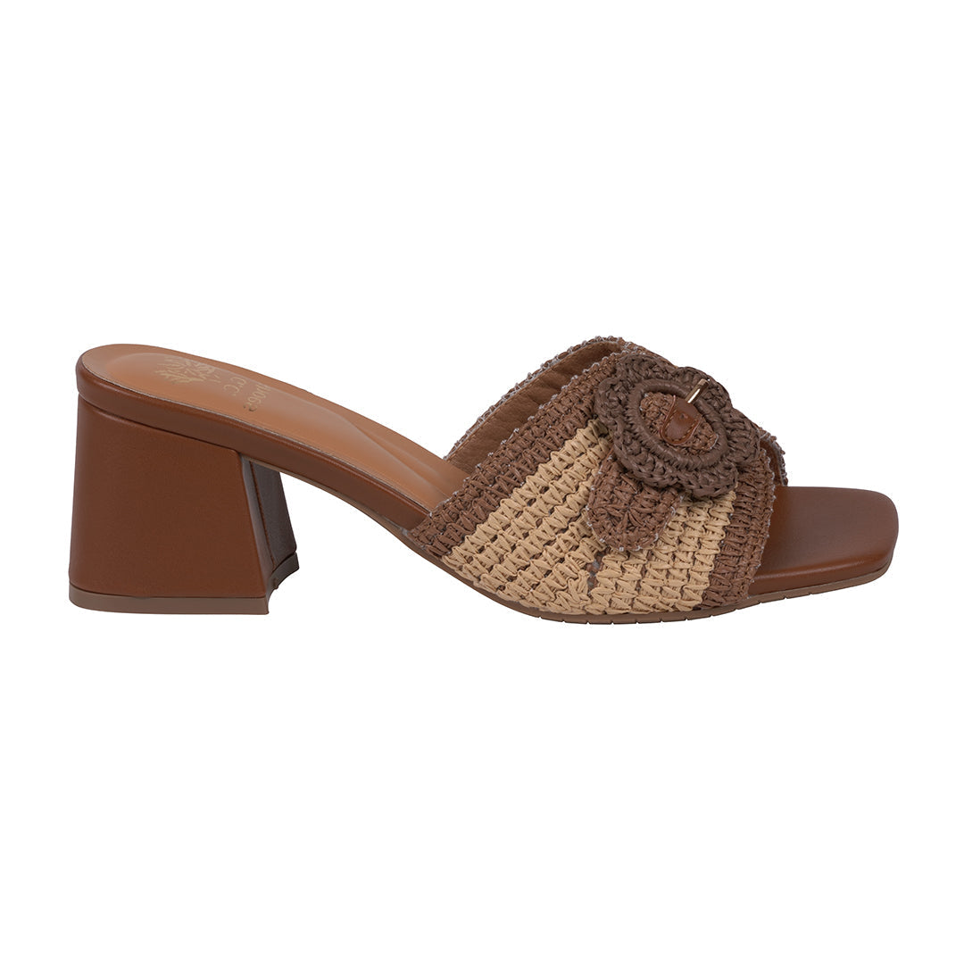 Brown and beige sandal with a flower detail on a white background