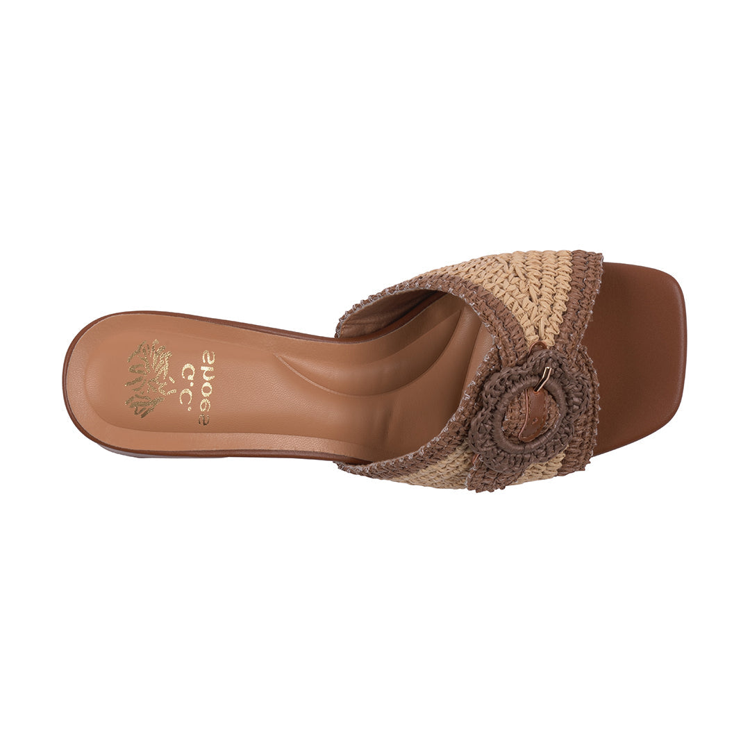 Brown sandal with woven strap on a white background