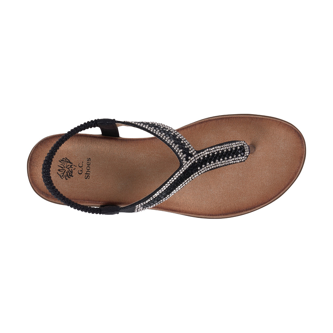 Brown sandal with black strap and rhinestone details on a white background