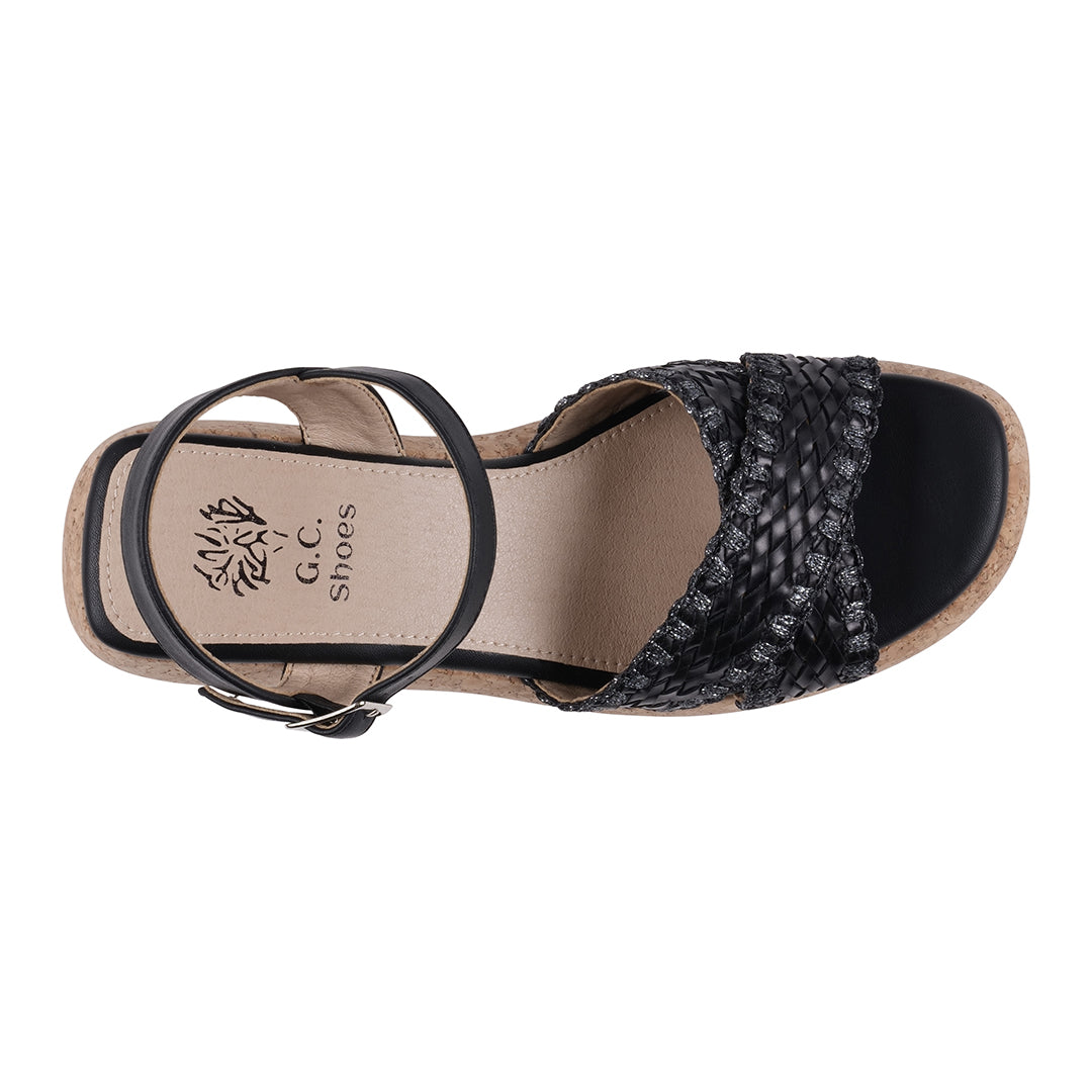 Black sandal with woven design on a white background