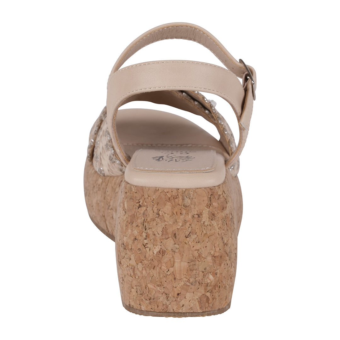 Beige sandal with cork wedge sole on a white background