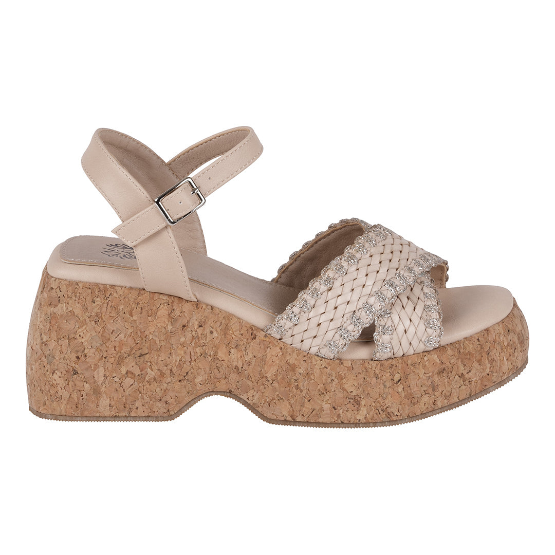 Beige sandal with cork wedge sole on a white background