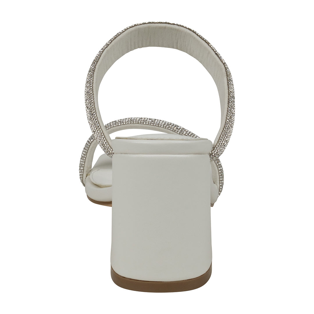 White sandal with decorative straps on a white background