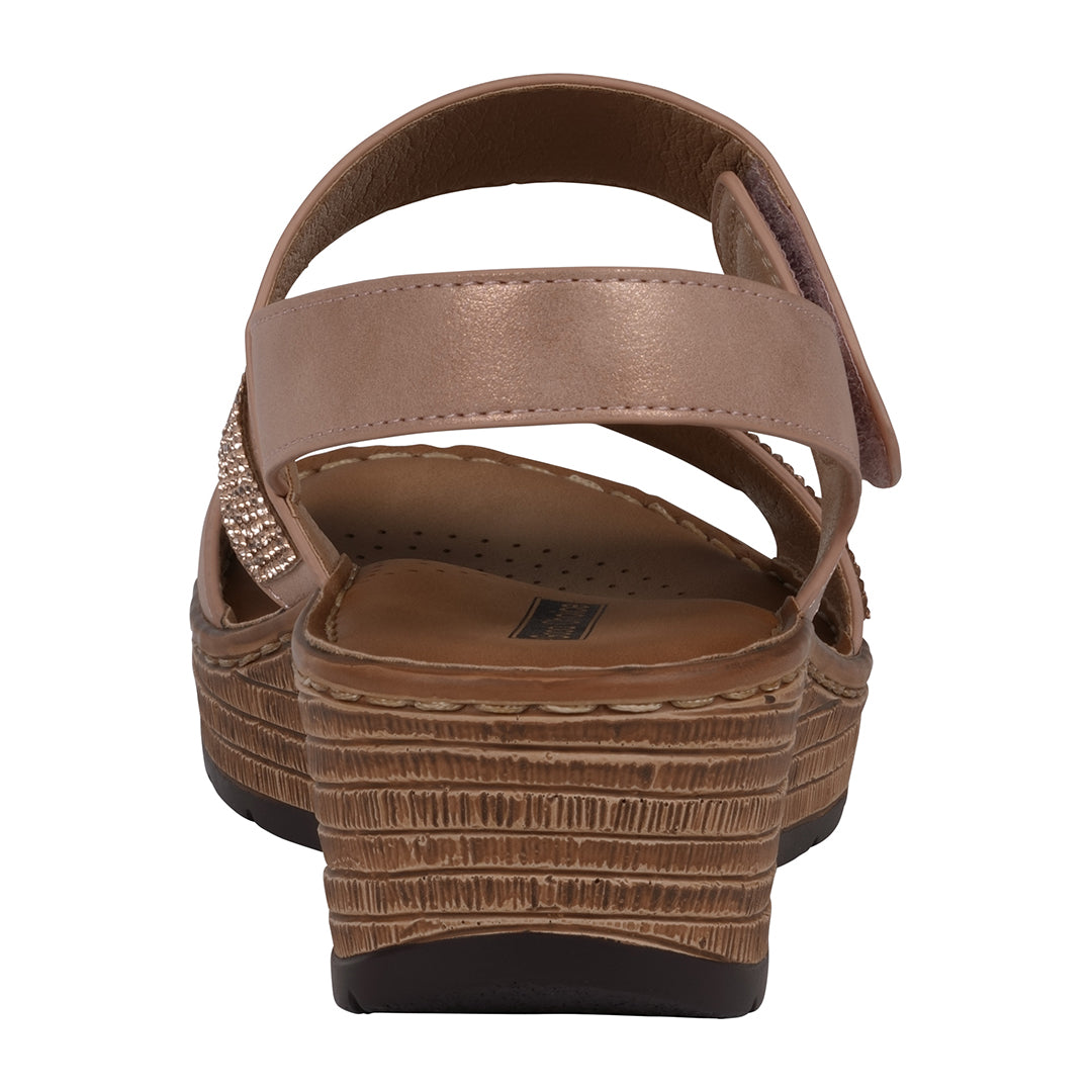 Brown sandal with a textured sole on a white background