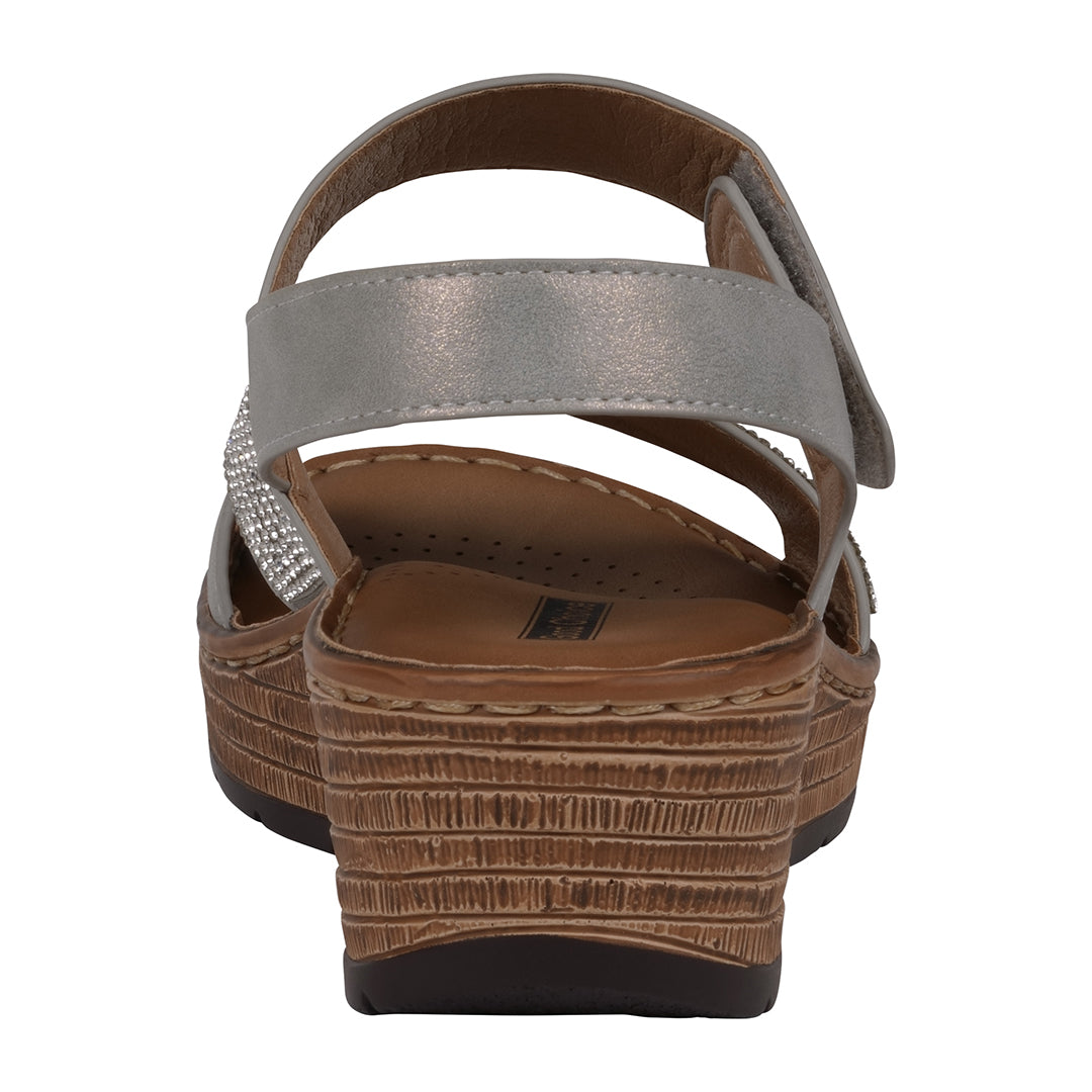 Brown sandal with a textured sole on a white background