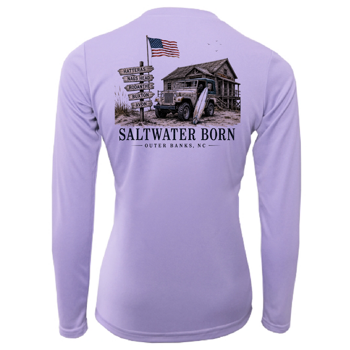 A light purple long-sleeve performance shirt shown from the back, featuring a large graphic print of a rustic cabin, an old jeep, a surfboard, a signpost with destinations, and an American flag above the text 'SALTWATER BORN OUTER BANKS, NC'.