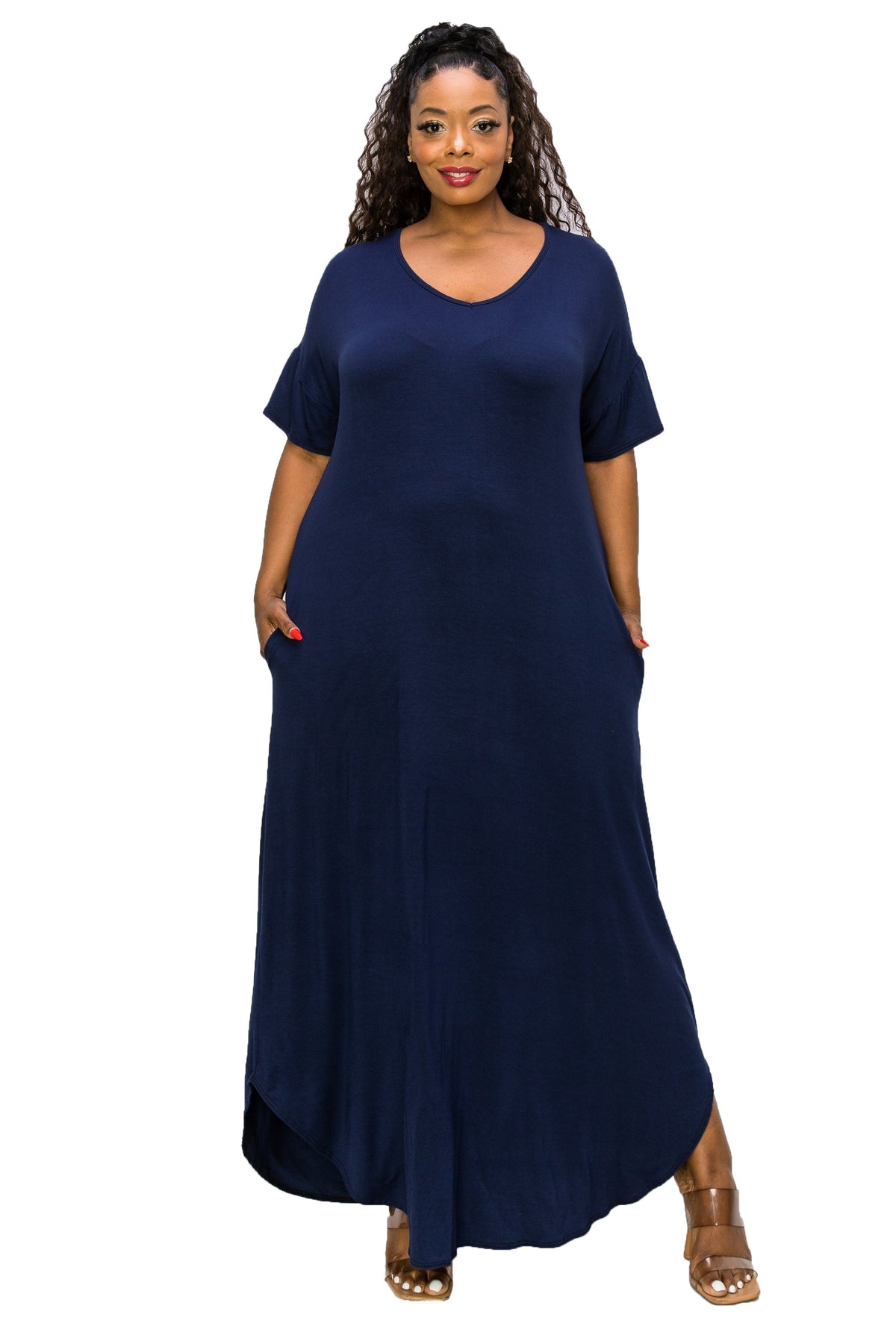 A woman modeling a navy blue maxi dress with short sleeves, a V-neckline, and side pockets, paired with brown sandals, set against a plain white background.