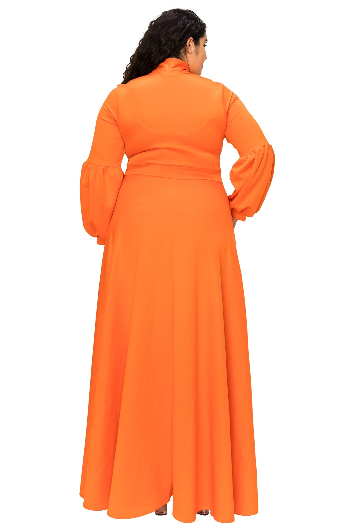 A woman shown from the back wearing a bright orange long-sleeve maxi dress with a high collar and a fitted waist, photographed against a plain white background.