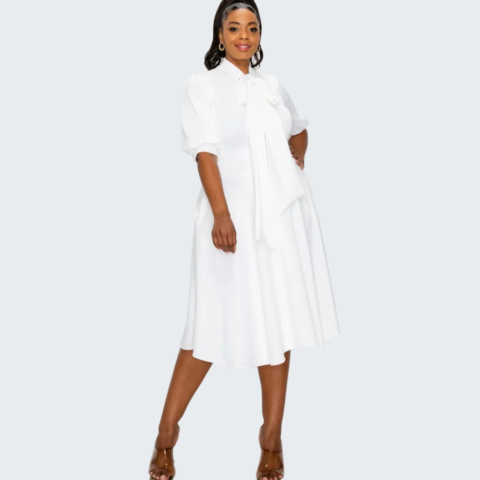 Woman wearing a white dress on a white background