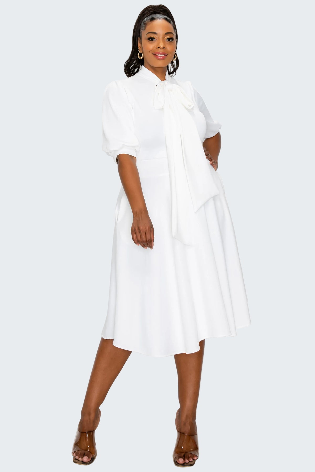 Woman wearing a white dress on a white background