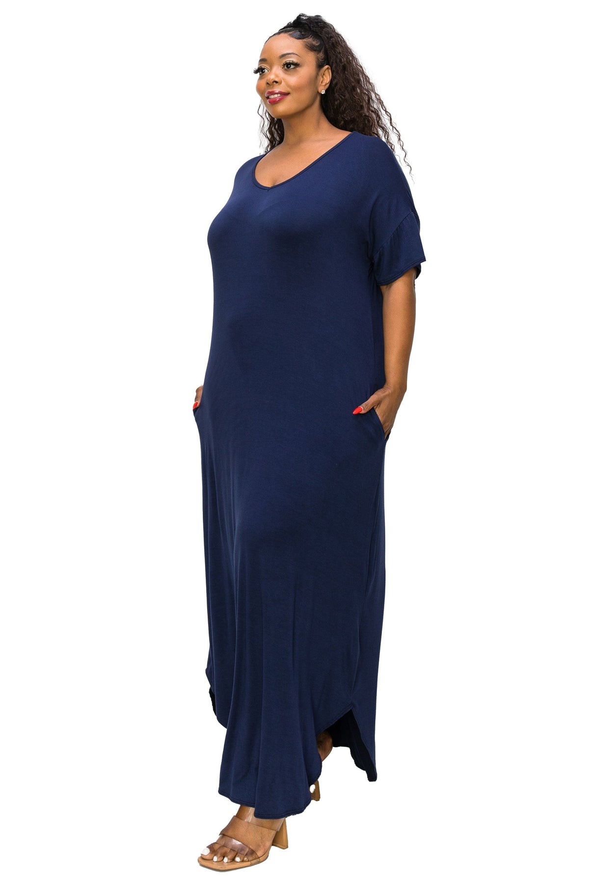 A woman modeling a navy blue maxi dress with short sleeves, a V-neckline, and side pockets, set against a plain white background.