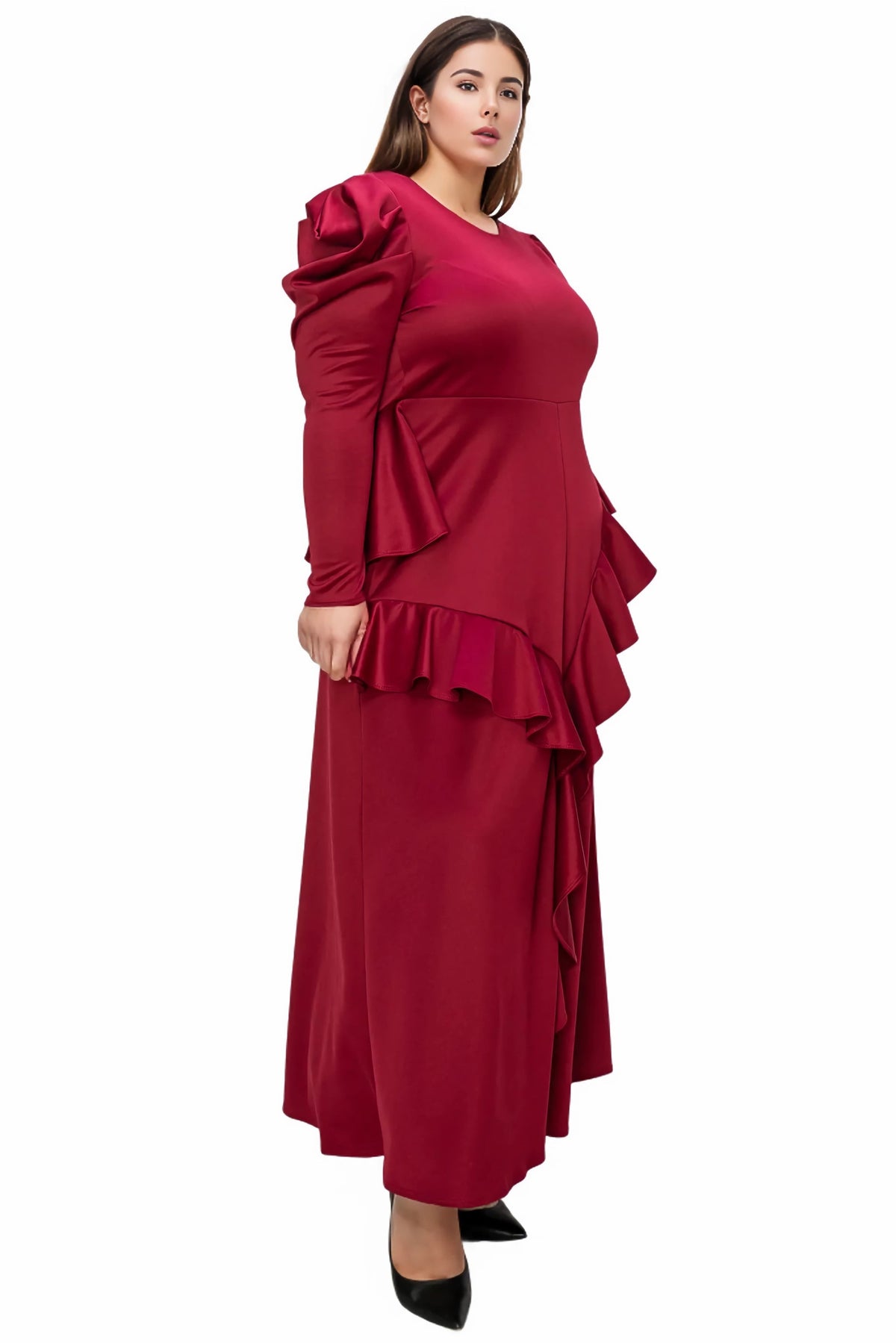 A woman modeling a long-sleeve maxi dress in deep burgundy red, featuring dramatic ruffled detailing on the shoulders and a layered ruffle hemline, set against a plain white background.