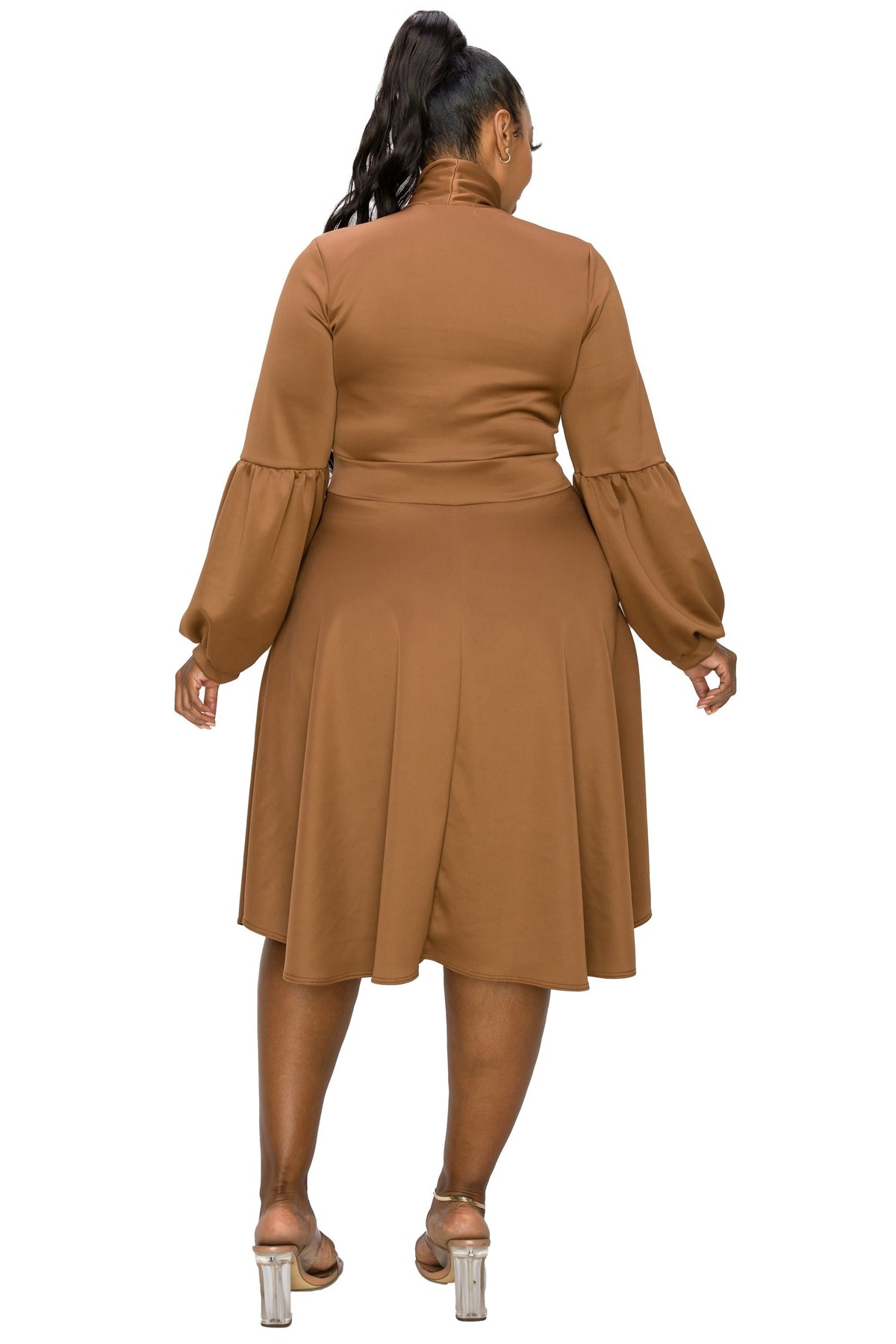 A woman shown from the back wearing a brown long-sleeve midi dress with balloon sleeves and a high mock neck, paired with clear high-heeled sandals, against a plain white background.
