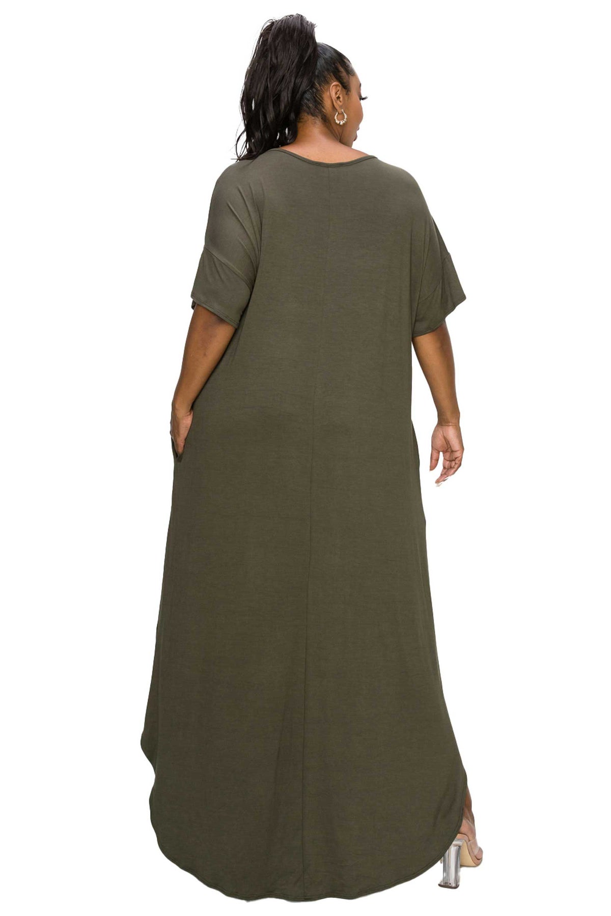 A woman shown from the back wearing a loose, short-sleeve maxi dress in olive green, photographed against a plain white studio background.