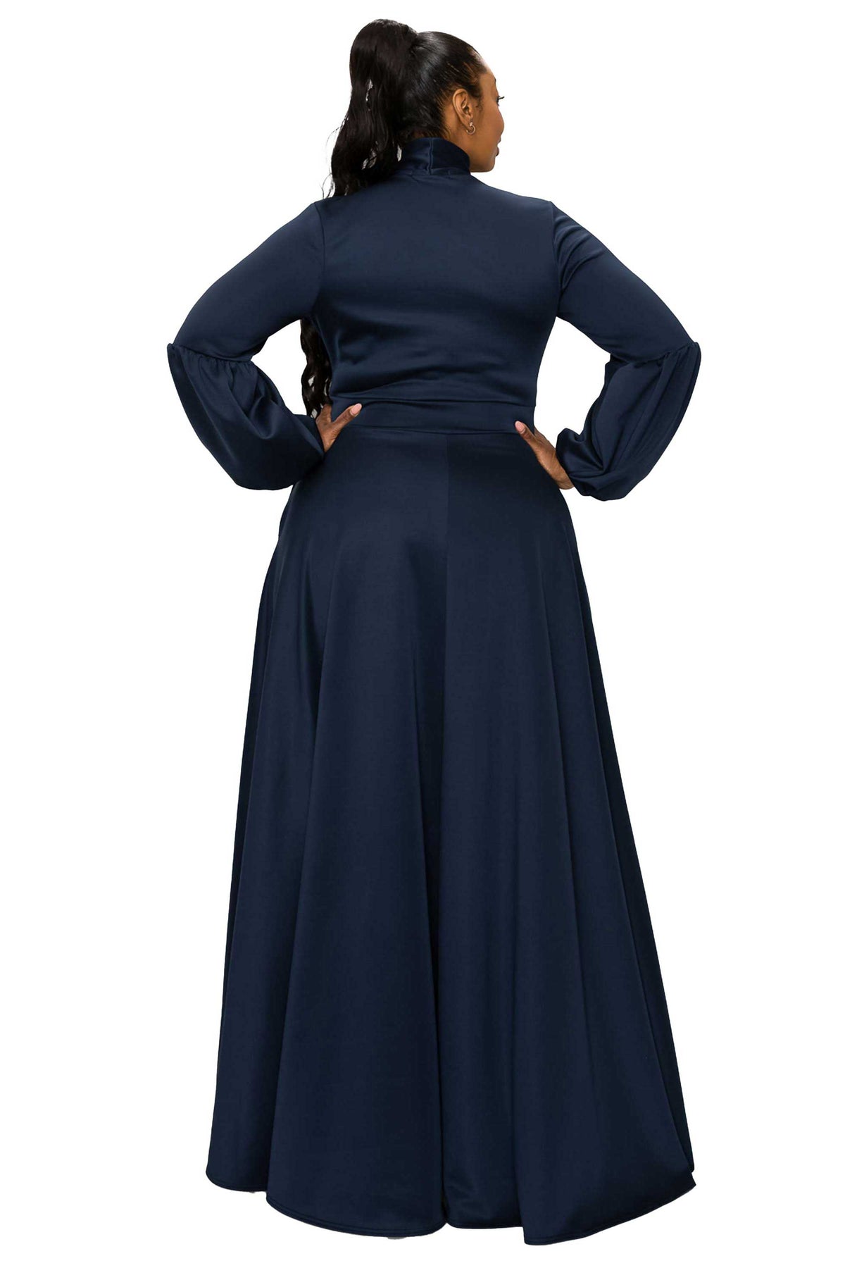 A woman wearing a long navy blue maxi dress, shown from the back against a solid white background.
