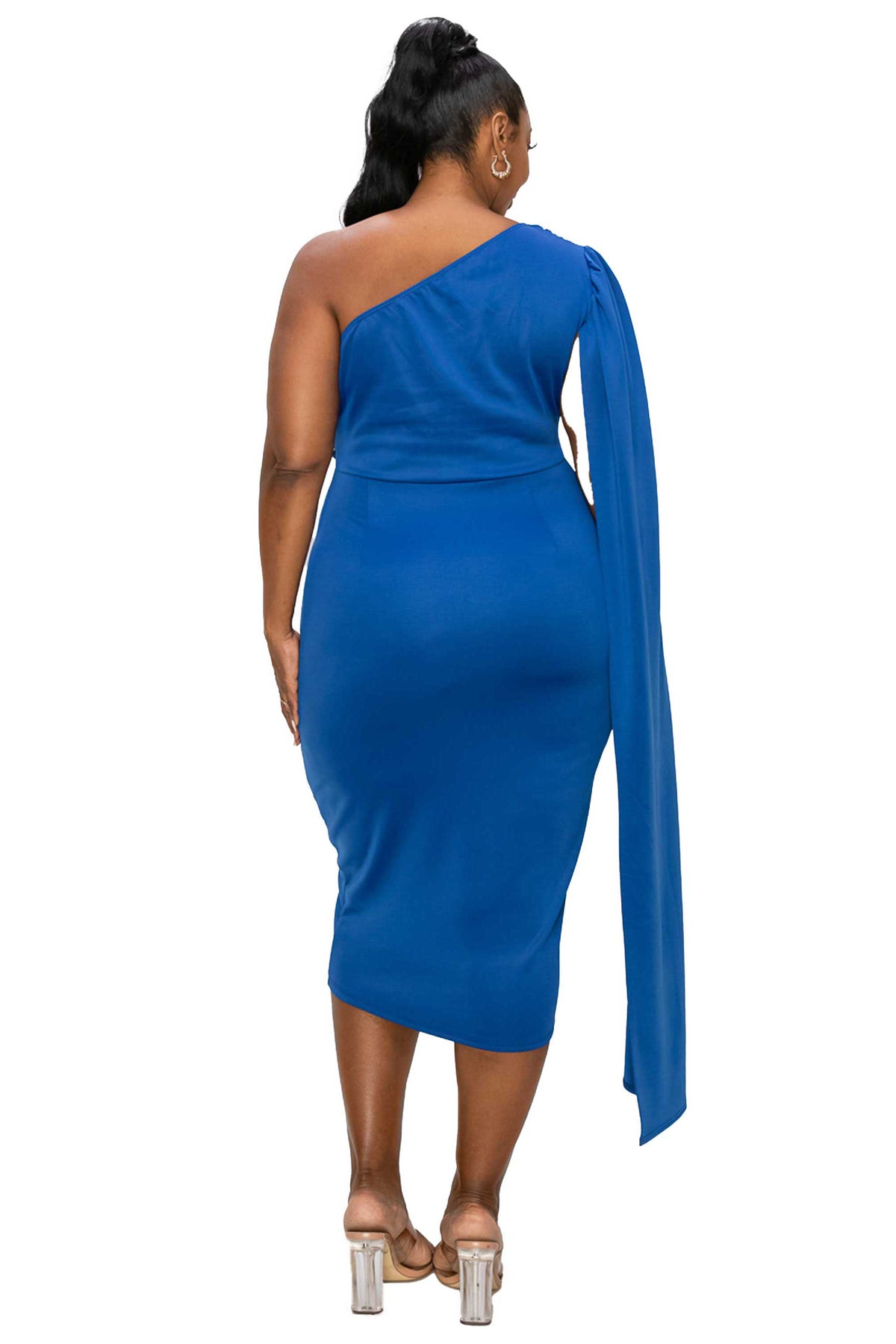 A woman shown from the back wearing a royal blue one-shoulder midi dress with a long draped sleeve, paired with clear high-heeled sandals, against a plain white background.