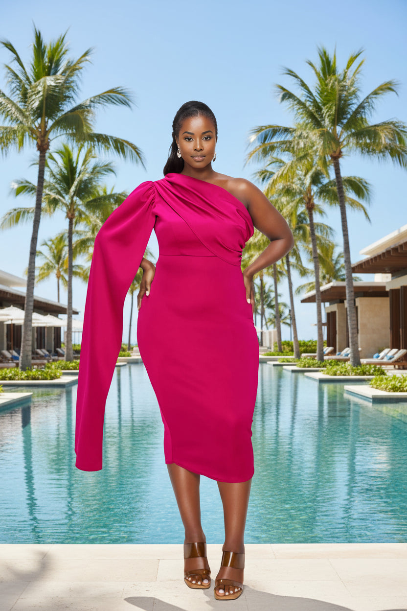 A woman modeling a bright fuchsia pink one-shoulder midi dress with a dramatic draped neckline and a long flowing sleeve, paired with brown strappy heels against a plain white background.