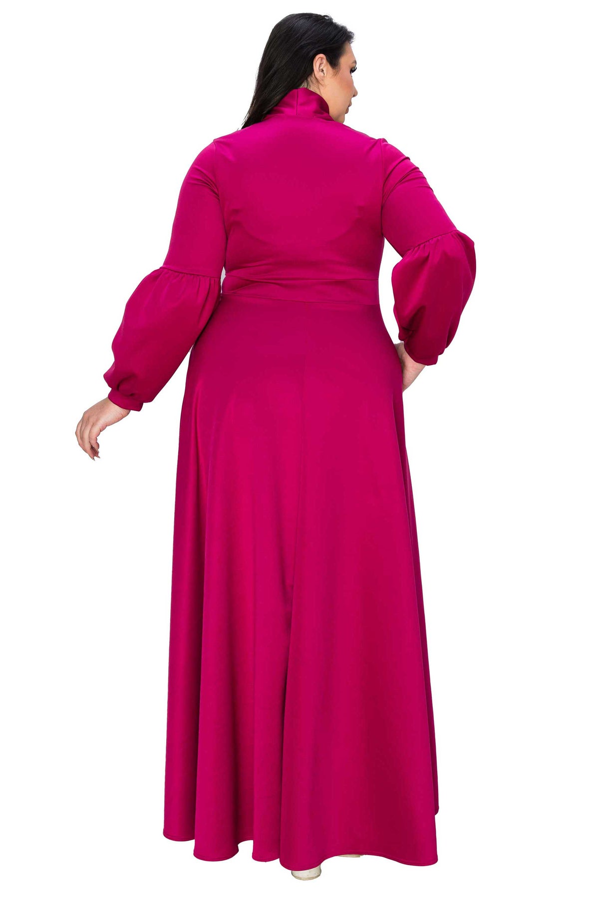 A woman modeling a long magenta maxi dress from the back, featuring a high mock neck, voluminous balloon sleeves, and a gathered waist, set against a plain white background.