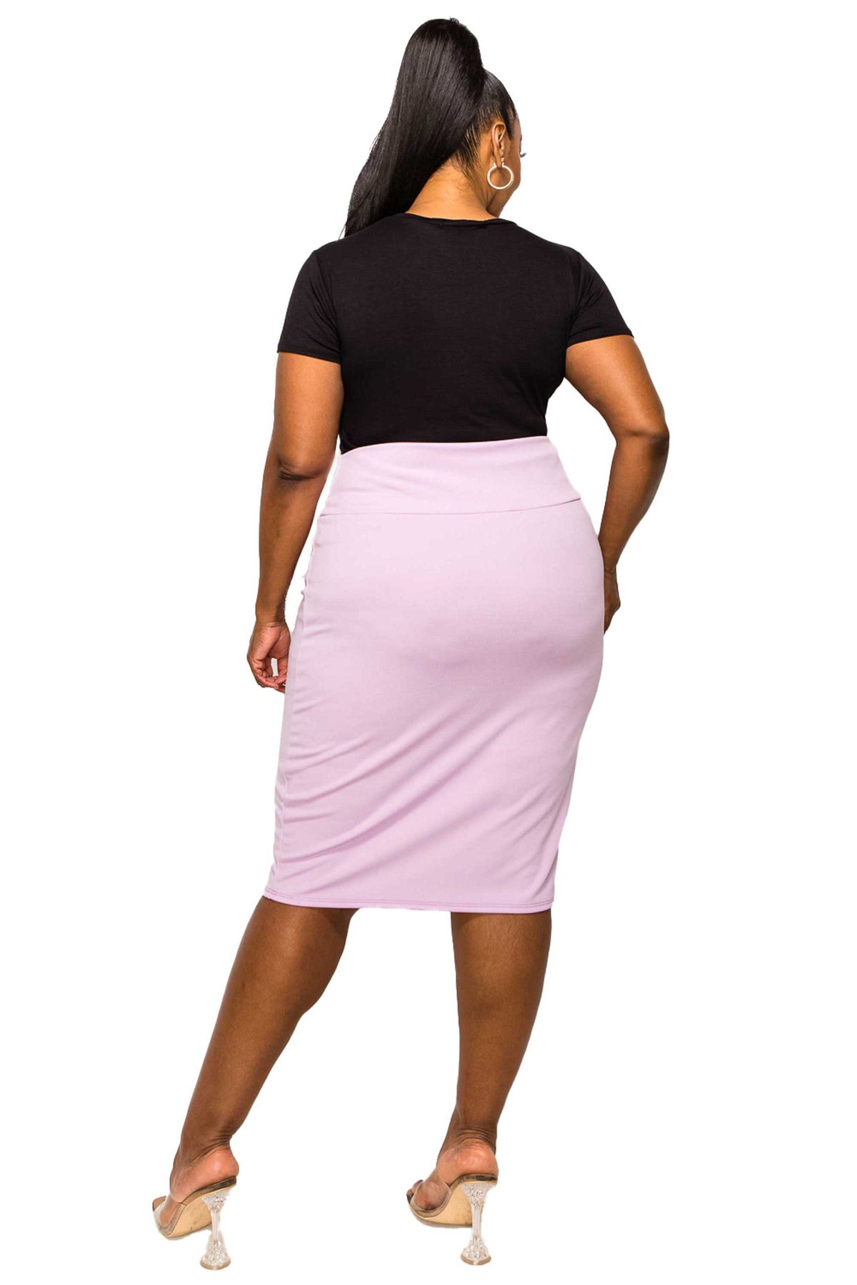 A woman shown from the back wearing a black short-sleeve crop top and a light pink knee-length pencil skirt, paired with beige high-heeled sandals, against a plain white background.