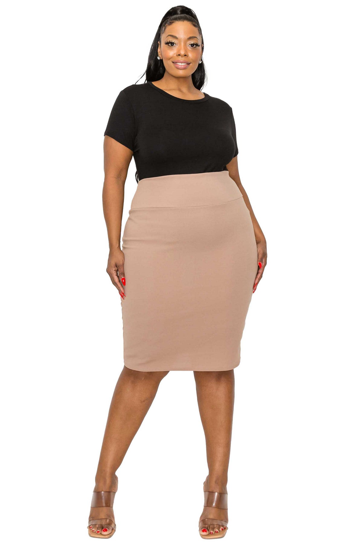 A woman modeling a two-piece outfit consisting of a black short-sleeve crewneck top and a beige high-waisted knee-length pencil skirt, paired with clear-strap high heels, against a plain white background.