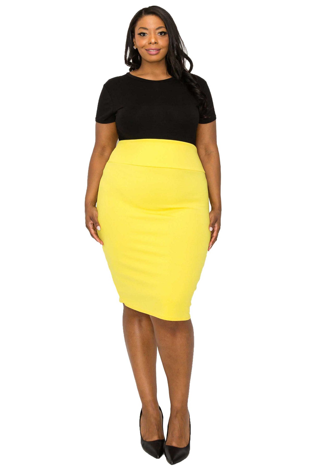 A woman modeling a color-block midi dress with a black short-sleeve top and a bright yellow fitted skirt, paired with black heels, against a plain white background.