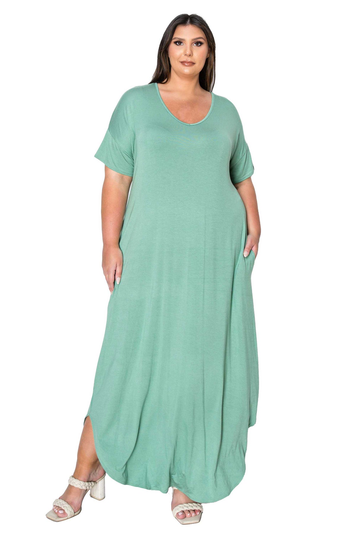 A woman modeling a sage green short-sleeve maxi dress with a scoop neckline, shown against a plain white background.