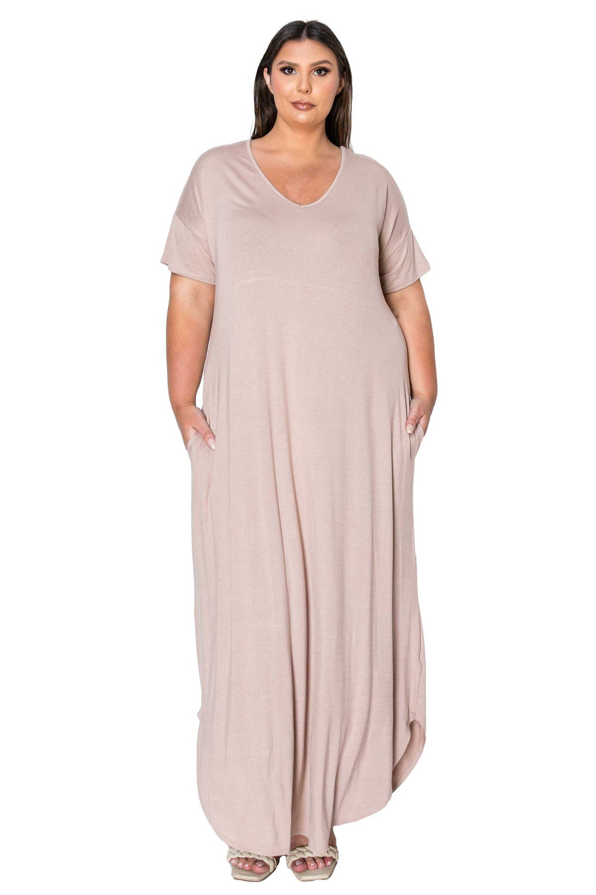 A woman modeling a dusty pink short-sleeve maxi dress with side pockets, shown against a plain white background.
