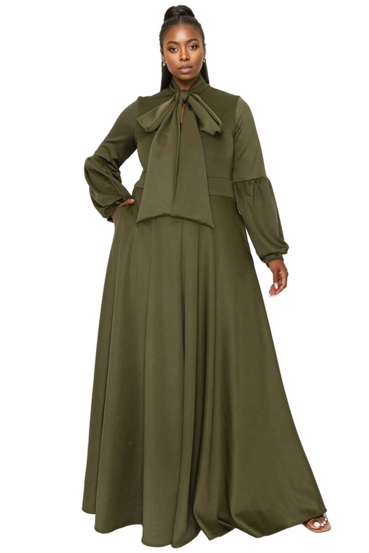 Woman wearing an olive green outfit with a long dress and matching top on a white background