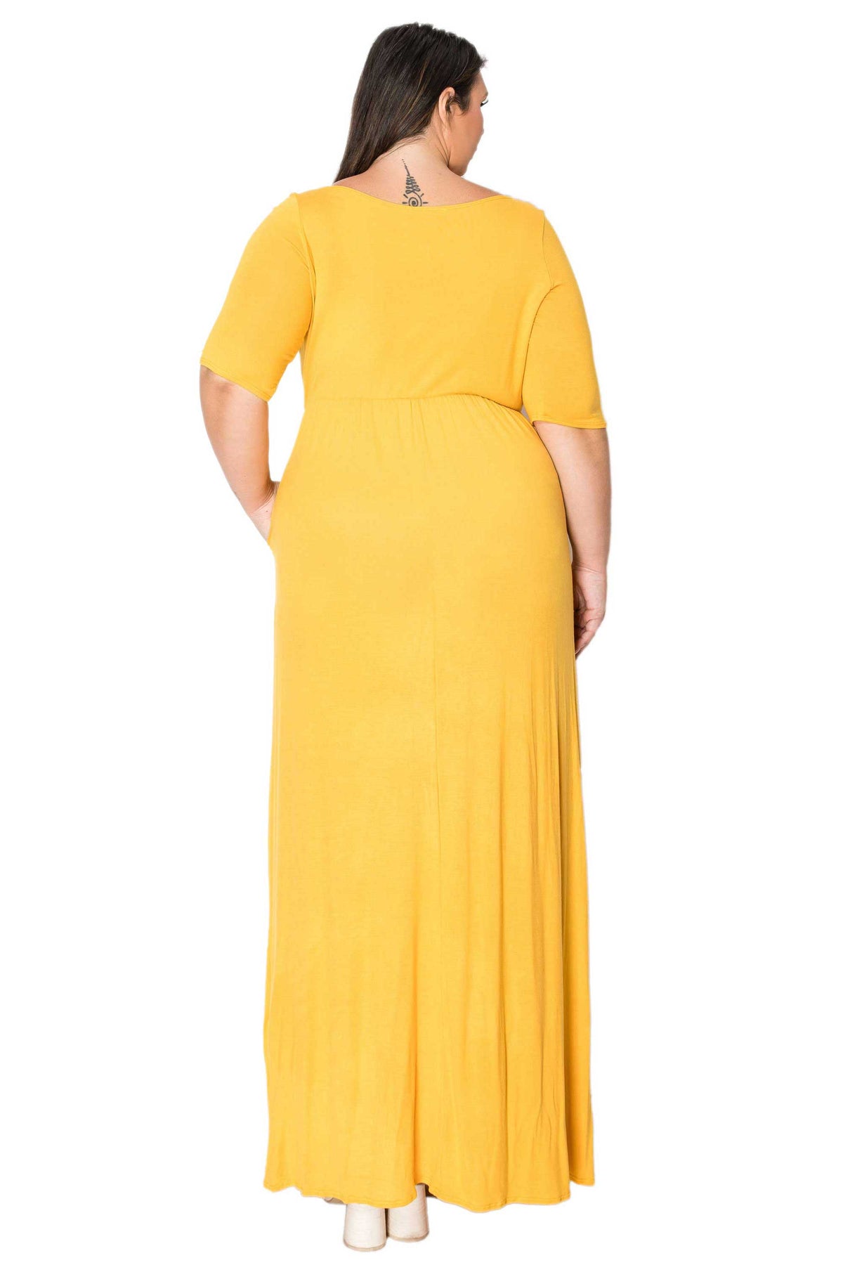 A woman viewed from the back wearing a bright yellow short-sleeve maxi dress, standing against a plain white background.