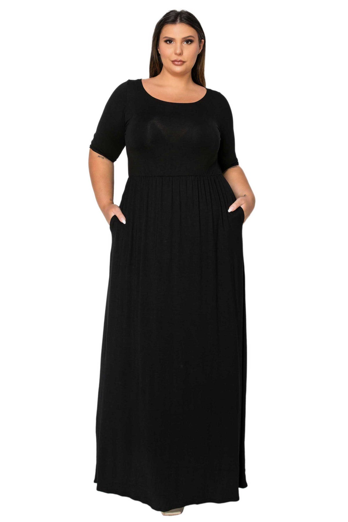 A woman modeling a black short-sleeve maxi dress with side pockets against a plain white background.