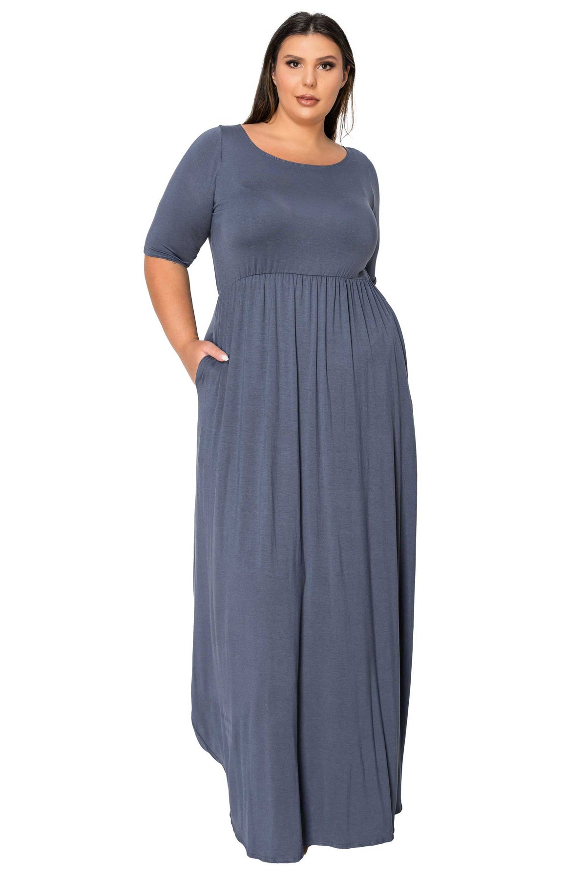 A woman modeling a slate blue-gray maxi dress with short sleeves, a round neckline, and side pockets against a plain white background.
