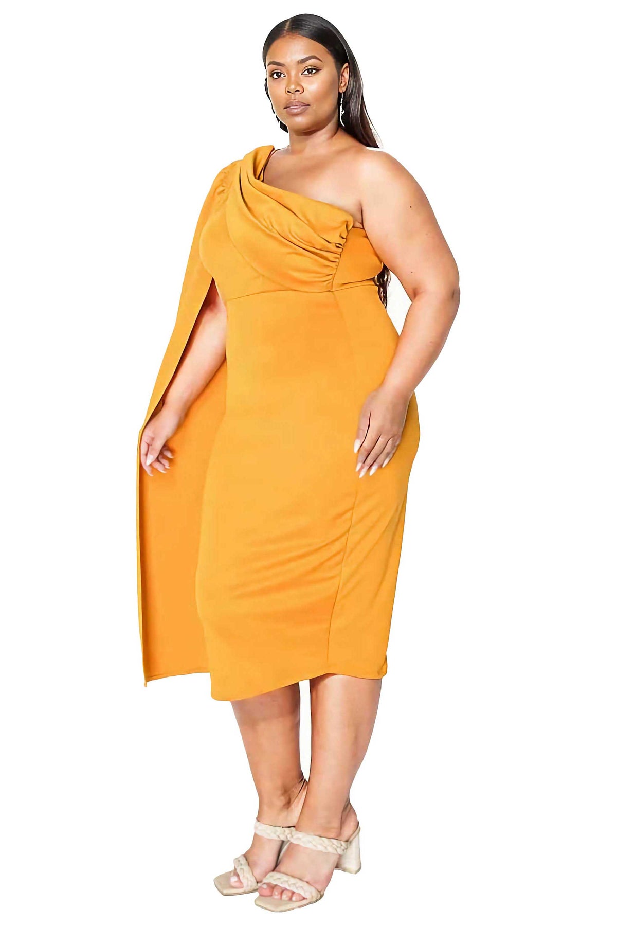 A woman modeling a mustard yellow one-shoulder midi dress with a draped neckline and a side slit, paired with beige strappy heels against a plain white background.