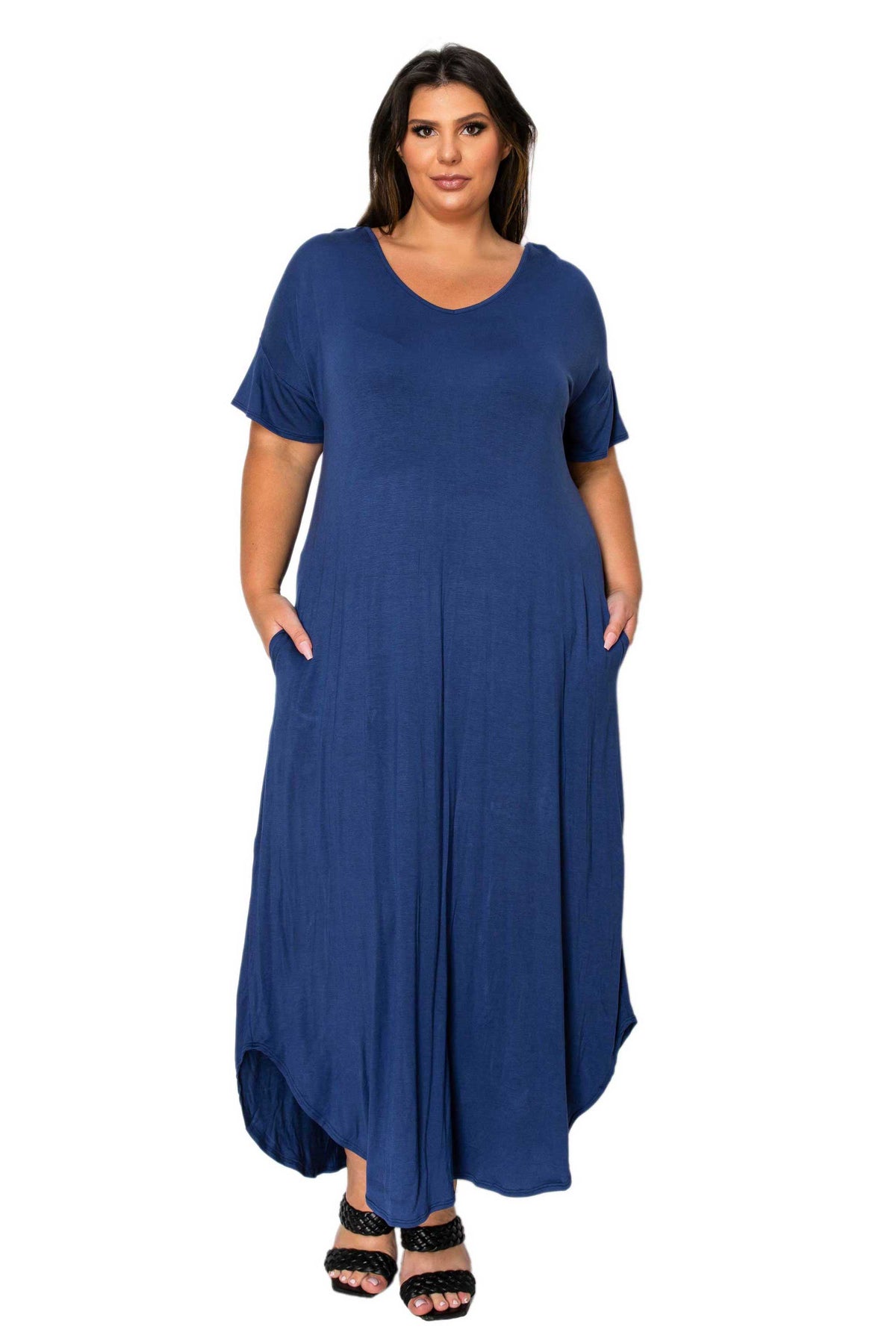 A woman modeling a short-sleeve, high-low maxi dress in a solid navy blue color, featuring side pockets and a relaxed fit, set against a plain white background.