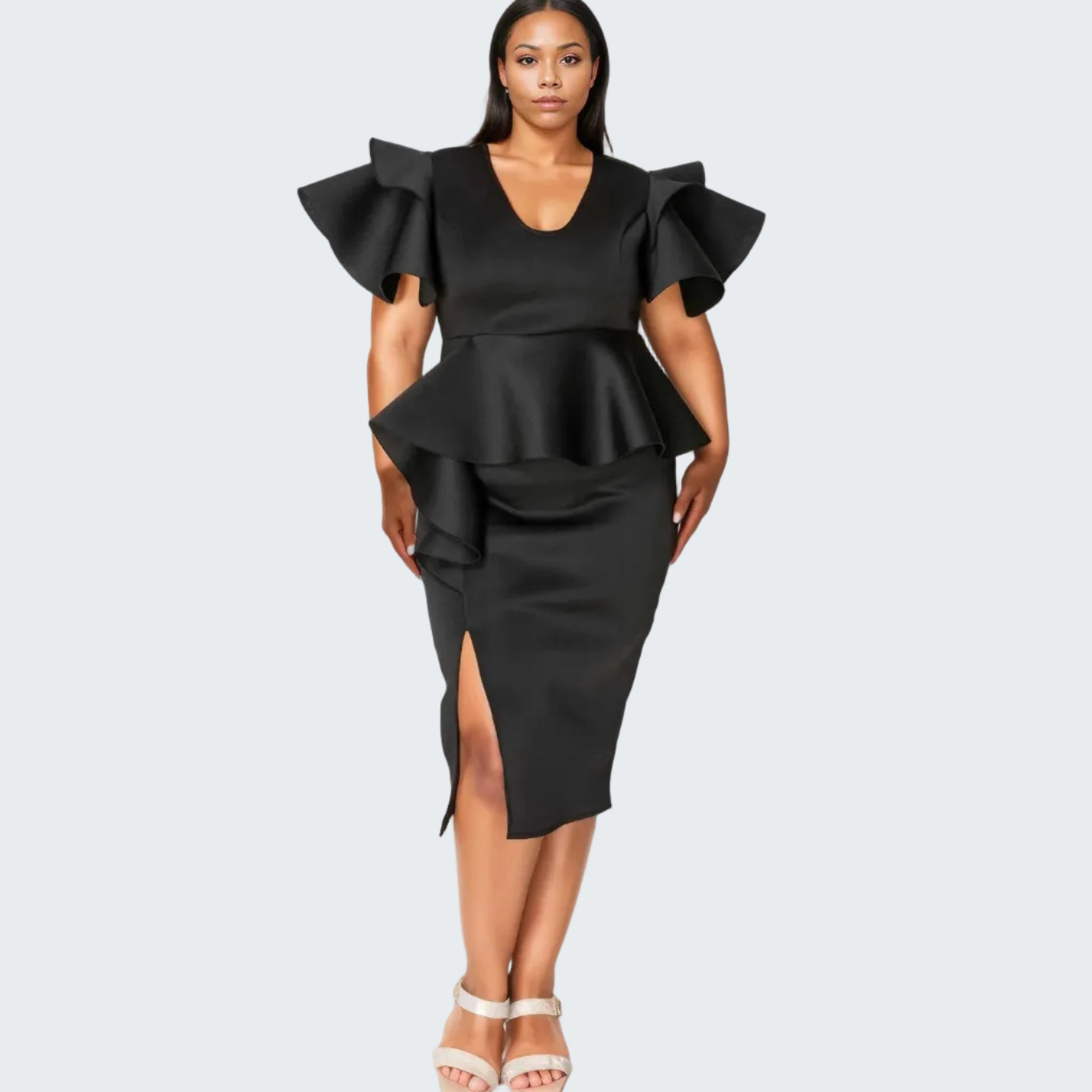 A woman modeling a black satin-like midi dress with dramatic ruffled cap sleeves, a peplum waist, and a side slit, photographed against a plain white studio background.