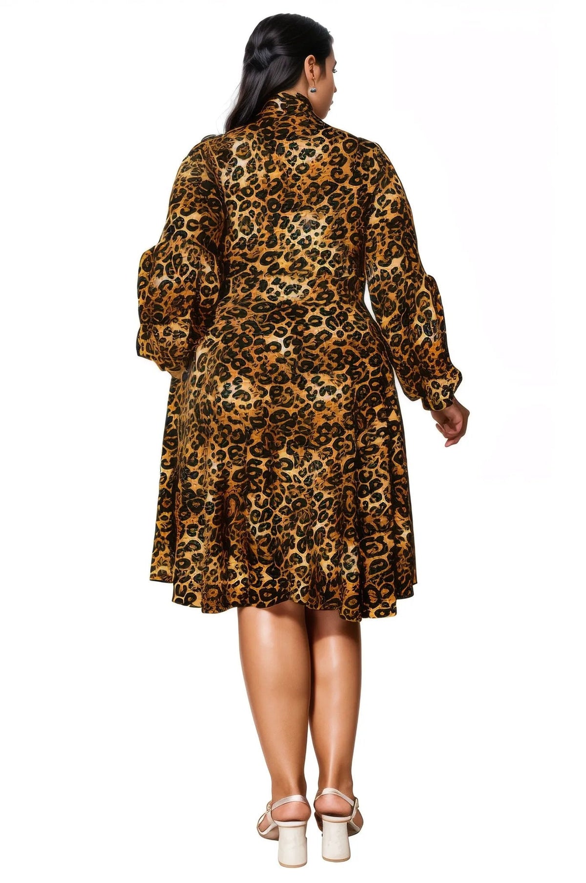 A woman viewed from the back wearing a leopard-print long-sleeve dress with a high collar and flared skirt, paired with beige high-heeled sandals, against a plain white background.
