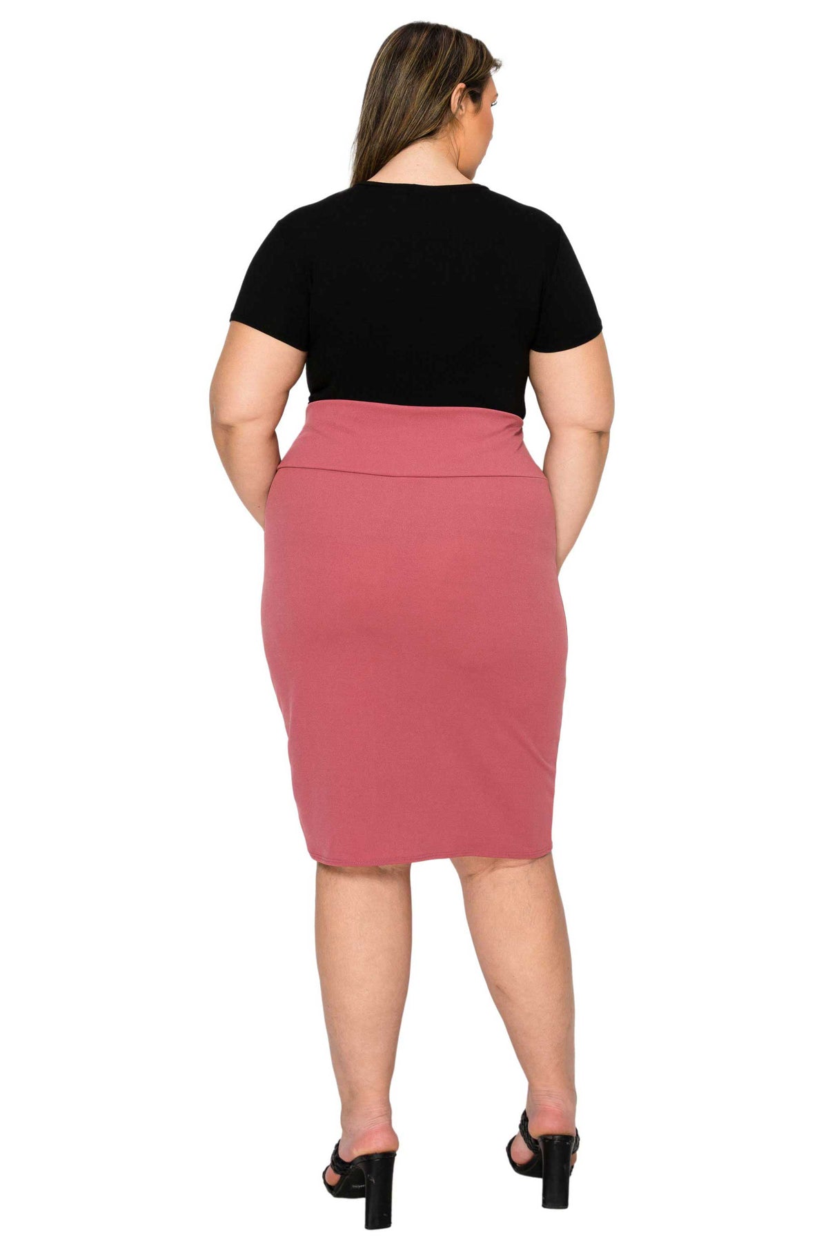 A woman shown from the back wearing a black short-sleeve top and a dusty rose pink knee-length pencil skirt, paired with black high-heeled sandals, against a plain white background.