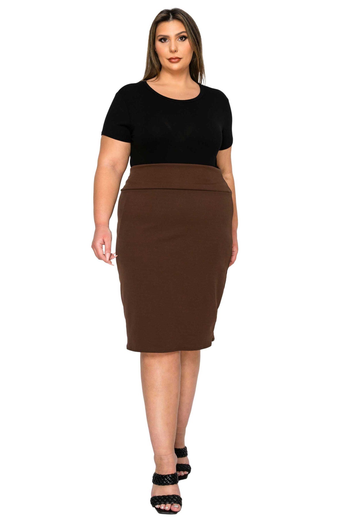 A woman modeling a two-piece outfit consisting of a black short-sleeve crewneck top and a brown high-waisted knee-length pencil skirt, paired with black strappy heels, against a plain white background.