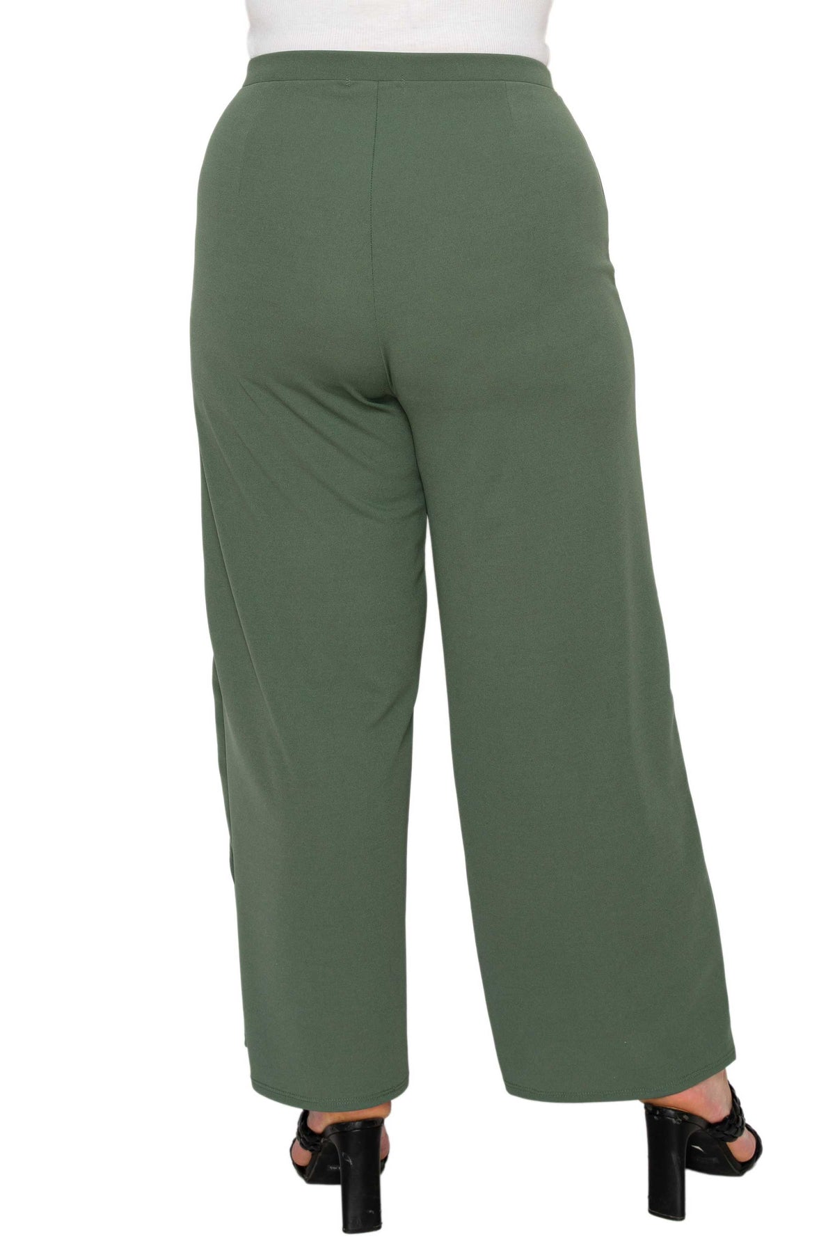 A person shown from the back wearing olive green wide-leg cropped pants with black heeled sandals against a plain white studio background.