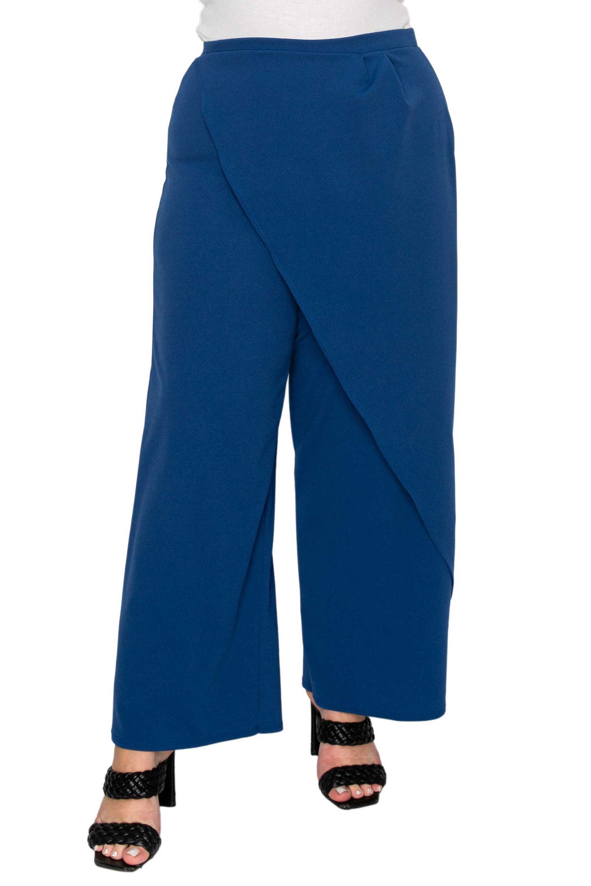 A person wearing royal blue wide-leg wrap pants with black strappy high-heeled sandals, shown from the waist down on a plain white background.
