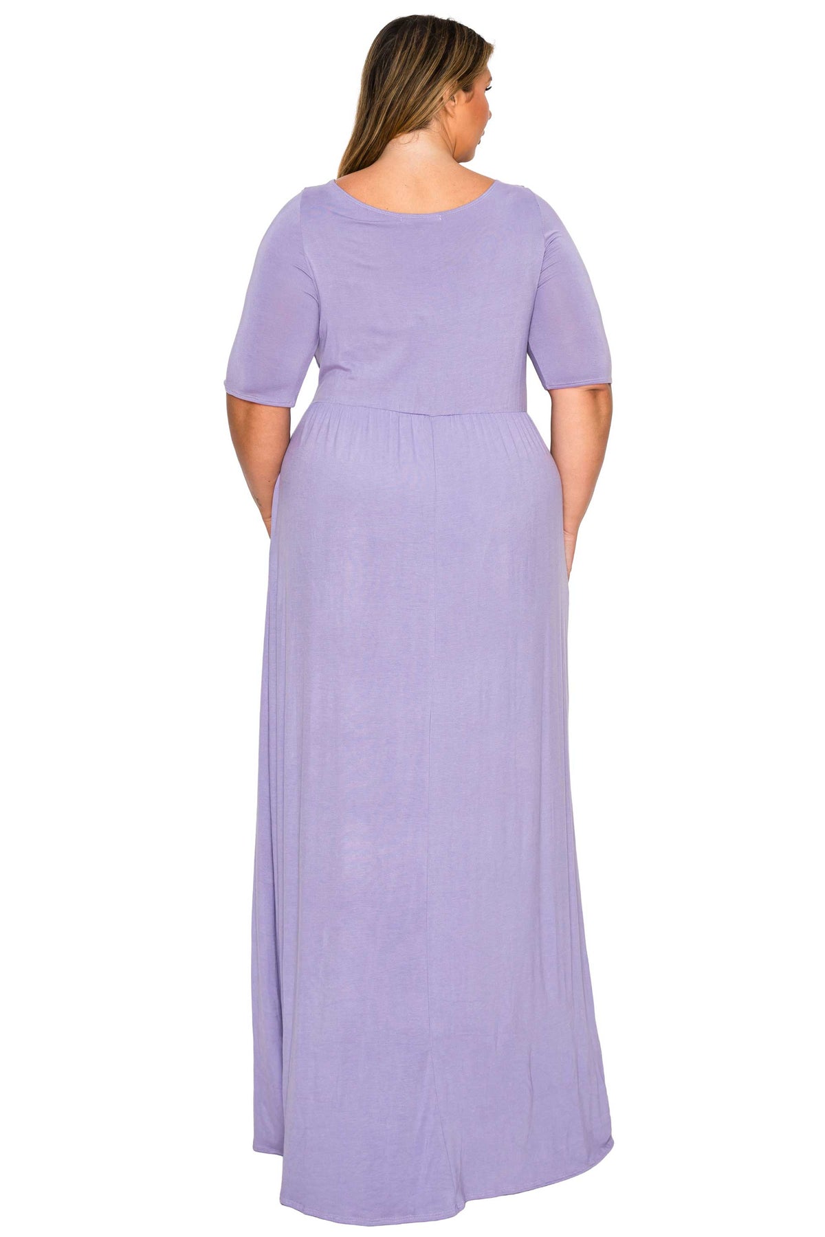 A woman viewed from the back wearing a lavender purple short-sleeve maxi dress with a gathered waist, set against a plain white background.
