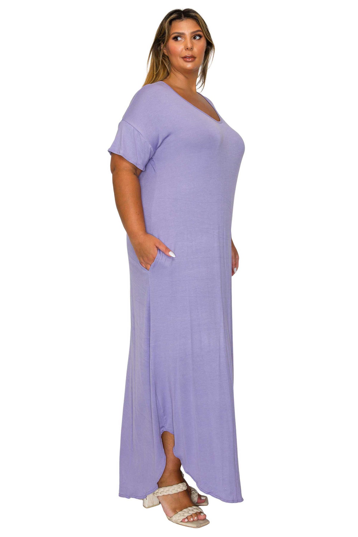 A woman modeling a lavender purple short-sleeve maxi dress with a V-neckline, standing against a plain white background.