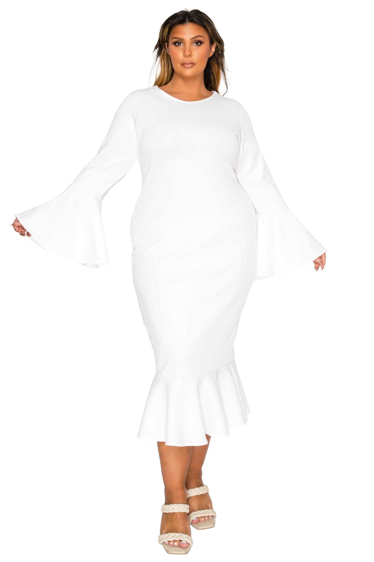 A woman modeling a white long-sleeve midi dress with flared bell sleeves and a ruffled hem, paired with white heeled sandals, against a plain white background.